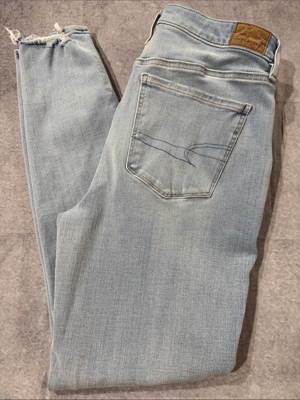 American Eagle Outfitters Light Blue Super High Rise Jeggings with frayed hem